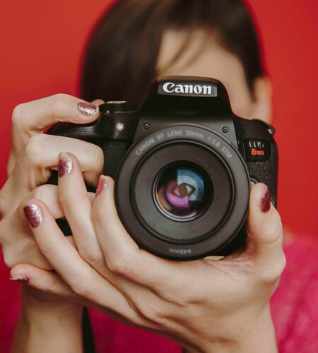 lady holding taking photo with canon camera in hand